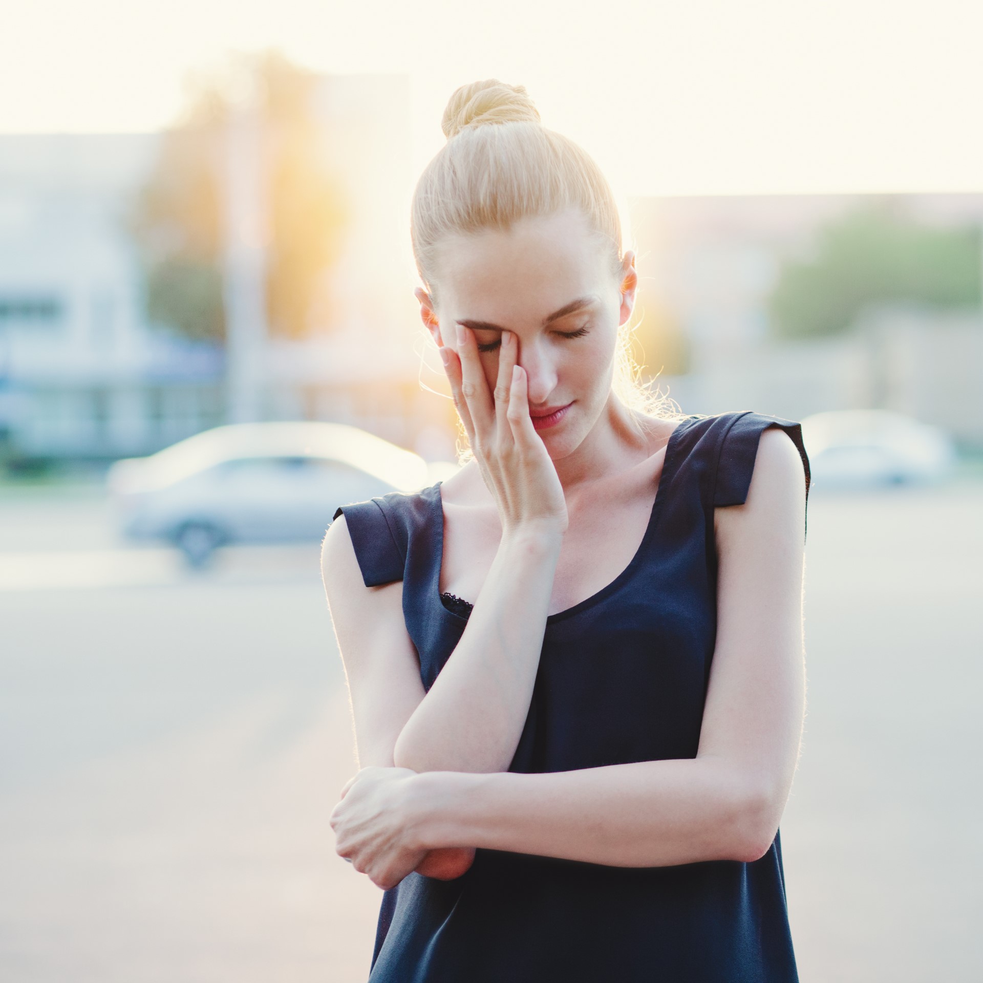 Emotive young beautiful woman posing on the street